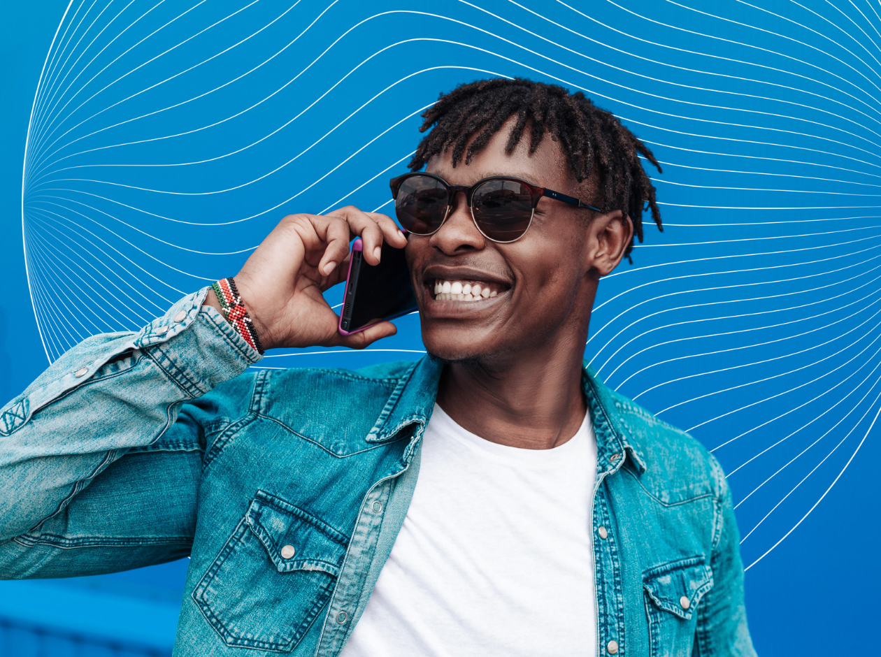 Black man speaking and smiling on mobile phone