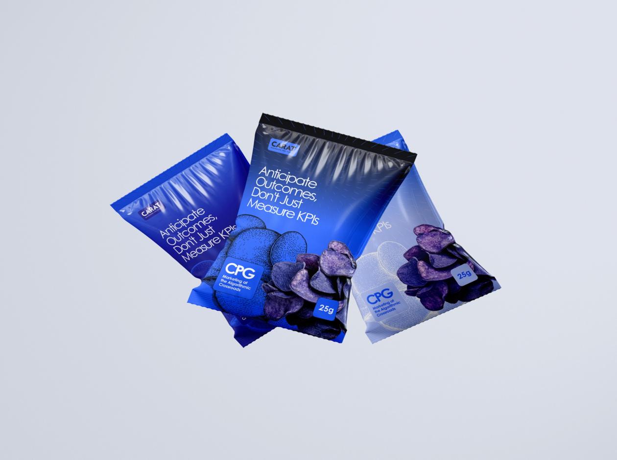 Three packets of blue potato chips with Carat branding, featuring the text ‘Anticipate Outcomes, Don’t Just Measure KPIs’ and a CPG label, displayed against a light background.