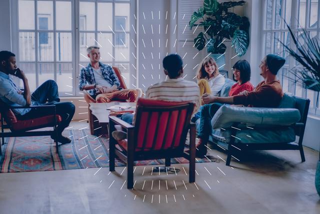 Image of a Group of Men and Women Sitting in Individual Comfy Chairs Having a Panel Discussion